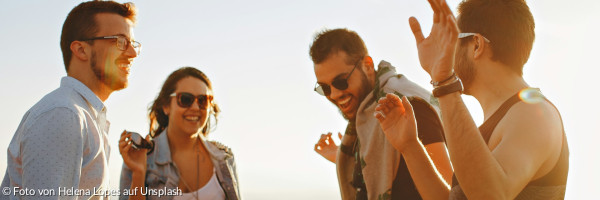 Drei Männer und eine Frau, die lachen